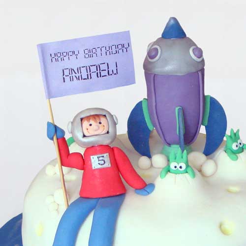 Novetly boys space birthday cake with spaceship and astronaut on the moon. Made by Ann White